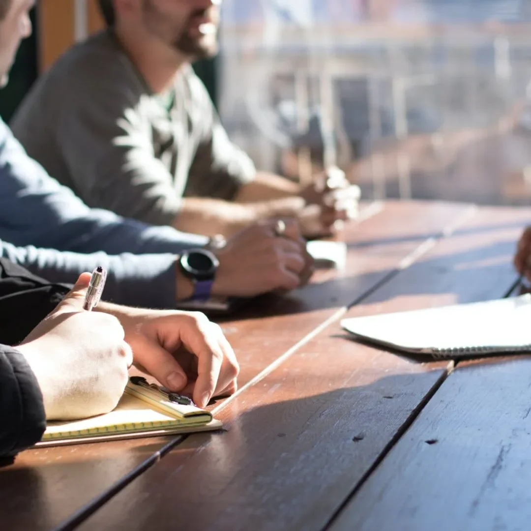 A group of people sitting together at a table